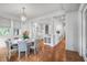 Bright dining area with hardwood floors and adjacent open kitchen, perfect for entertaining guests at 126 Balfour Dr, Charleston, SC 29492
