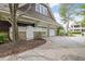 Beautiful home showcasing a large driveway with mature landscaping and three car garage at 126 Balfour Dr, Charleston, SC 29492