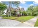 Charming home featuring a lush green lawn, manicured landscaping, and a welcoming facade with a two-car garage and lovely trees at 126 Balfour Dr, Charleston, SC 29492