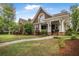 Inviting front exterior showcases a covered porch, well-kept lawn, and lush landscaping, perfect for curb appeal at 126 Balfour Dr, Charleston, SC 29492