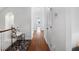 Bright hallway with hardwood floors, white walls, decorative furniture, and natural light at 126 Balfour Dr, Charleston, SC 29492