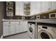 Well-equipped laundry room with white cabinets, modern appliances, and ample counter space at 126 Balfour Dr, Charleston, SC 29492