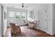 This spacious office has natural light, white walls, ceiling fan, and hardwood floors at 126 Balfour Dr, Charleston, SC 29492
