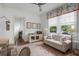 Bright sitting room featuring a patterned sofa, large windows, and tasteful decor for a relaxed atmosphere at 126 Balfour Dr, Charleston, SC 29492