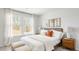 Bright bedroom featuring large windows, neutral walls, plush bedding, and decorative side tables with modern lamps at 132 Haventree Ct, Summerville, SC 29486