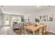 Bright dining area with a wood table, seamlessly connected to the living room and a door to the yard at 132 Haventree Ct, Summerville, SC 29486