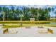 A gorgeous community area showcasing the horseshoe pits, a pond and picnic tables surrounded by beautiful trees at 134 Haventree Ct, Summerville, SC 29486