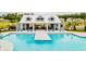 A gorgeous community pool with a spacious deck and lounge chairs under a covered cabana area at 134 Haventree Ct, Summerville, SC 29486