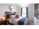 Bedroom with large window, stylish decor, neutral walls, and cozy bedding at 136 Haventree Ct, Summerville, SC 29486