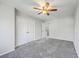 Spacious bedroom featuring neutral carpet, ceiling fan, and large closet space at 1421 Dove Run Dr # C, Charleston, SC 29412