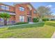 Traditional brick townhouse with manicured lawn and walkway to entrance at 1421 Dove Run Dr # C, Charleston, SC 29412