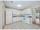 Bright kitchen features white appliances, ample cabinet space, and tile flooring at 1421 Dove Run Dr # C, Charleston, SC 29412