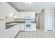 Well-lit kitchen with white cabinets, appliances and tile flooring at 1421 Dove Run Dr # C, Charleston, SC 29412