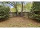 Spacious backyard with mature trees and a privacy fence, offering a tranquil outdoor space at 181 Commons Way, Goose Creek, SC 29445