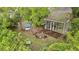 Aerial view of backyard featuring screened porch, fire pit, seating, dining table, and lush landscaping at 181 Commons Way, Goose Creek, SC 29445