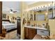 This bathroom features a double sink with a shared mirror, and an open doorway that leads to the bedroom at 181 Commons Way, Goose Creek, SC 29445