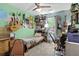 Small bedroom with a single bed, bright light, and many instruments hung up on the colorful walls at 181 Commons Way, Goose Creek, SC 29445