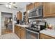 A kitchen featuring wooden cabinets, stainless steel appliances and an open doorway leading to another room at 181 Commons Way, Goose Creek, SC 29445