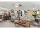 Cozy living room featuring neutral tones, a ceiling fan, and ample natural light for a welcoming atmosphere at 181 Commons Way, Goose Creek, SC 29445