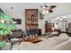 Inviting living room with a prominent brick fireplace, ceiling fan, and plush seating for relaxation at 181 Commons Way, Goose Creek, SC 29445