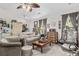 Comfortable living room with neutral color scheme, ceiling fan, and classic decor elements and furnishings at 181 Commons Way, Goose Creek, SC 29445