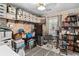 This home office features shelves lined with organized storage boxes, a desk area, and a filled bookcase at 181 Commons Way, Goose Creek, SC 29445