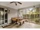 Screened-in porch with a wooden dining table and bench seating, overlooking the backyard at 181 Commons Way, Goose Creek, SC 29445