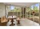 Enjoy a relaxing sunroom with a dining table and bench seating perfect for enjoying meals with a view at 181 Commons Way, Goose Creek, SC 29445