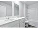 Well-lit bathroom featuring a double sink vanity and bathtub with shower at 181 Morning View Way, Moncks Corner, SC 29461
