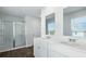 Bright bathroom with dual sinks, modern fixtures, and glass-enclosed shower at 181 Morning View Way, Moncks Corner, SC 29461