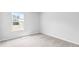 Bedroom with plush carpeting and a window with exterior view and neutral wall paint at 181 Morning View Way, Moncks Corner, SC 29461