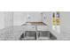 The kitchen has stainless steel sinks and faucet set in granite countertops, with a view into the living room at 181 Morning View Way, Moncks Corner, SC 29461