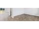 A living room showcasing the luxury vinyl flooring and leading to a bathroom and sliding door to the backyard at 181 Morning View Way, Moncks Corner, SC 29461