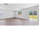 Open living room with wood-look flooring and sliding glass doors leading to the backyard at 181 Morning View Way, Moncks Corner, SC 29461