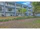 Exterior of a multi-story residential building with well-maintained lawns and lush landscaping at 1816 Orangeburg St, North Charleston, SC 29405