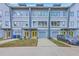 Modern townhome with light-blue siding, gray trim, yellow doors, and single-car garages at 1816 Orangeburg St, North Charleston, SC 29405
