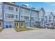 Contemporary townhomes with attached garages, vibrant doors, and beautifully manicured lawns at 1816 Orangeburg St, North Charleston, SC 29405