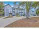 Row of newly constructed townhomes featuring modern design, shared driveway, and professional landscaping at 1816 Orangeburg St, North Charleston, SC 29405