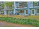 Exterior view of an apartment building showing private patios and landscaping at 1816 Orangeburg St, North Charleston, SC 29405