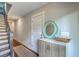 Inviting hallway featuring stairs, hardwood floors, neutral walls, a decorative mirror, and a storage cabinet at 1816 Orangeburg St, North Charleston, SC 29405