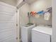 Functional laundry room with modern washer, dryer, and shelving for convenient storage at 1816 Orangeburg St, North Charleston, SC 29405