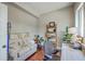 Cozy office area showcasing a comfortable sofa, wooden shelving, and an ergonomic chair for a productive workspace at 1816 Orangeburg St, North Charleston, SC 29405