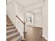 Inviting entryway showcasing wood floors, a staircase with white railings, and ample natural light, creating a warm ambiance at 1824 Nola Run, Summerville, SC 29485
