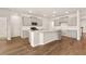 Modern kitchen featuring gray cabinetry, a stainless steel gas range, quartz countertops, and a center island with sink at 1824 Nola Run, Summerville, SC 29485