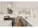 Stylish kitchen with gray cabinets, quartz counters, stainless steel appliances, and a center island, perfect for cooking at 1824 Nola Run, Summerville, SC 29485