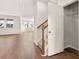 Spacious living area with wood floors, a view of the stairs, and an abundance of natural light from large windows at 1824 Nola Run, Summerville, SC 29485