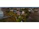 Stunning aerial view of an expansive home with solar panels, lush landscaping, and a private dock on the water at 1954 Sandy Point Ln, Mount Pleasant, SC 29466
