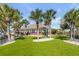 Manicured backyard with palm trees creates a private oasis, perfect for relaxation and enjoyment at 1954 Sandy Point Ln, Mount Pleasant, SC 29466