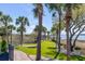Backyard with manicured lawn, mature landscaping, and water views at 1954 Sandy Point Ln, Mount Pleasant, SC 29466