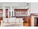 Entertainer's bar area with cherry wood cabinetry, granite counters, and glass shelving at 1954 Sandy Point Ln, Mount Pleasant, SC 29466